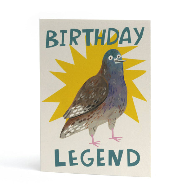 A whimsical birthday card featuring an illustration of a pigeon in front of a yellow starburst, with the words 'BIRTHDAY LEGEND' in teal lettering.