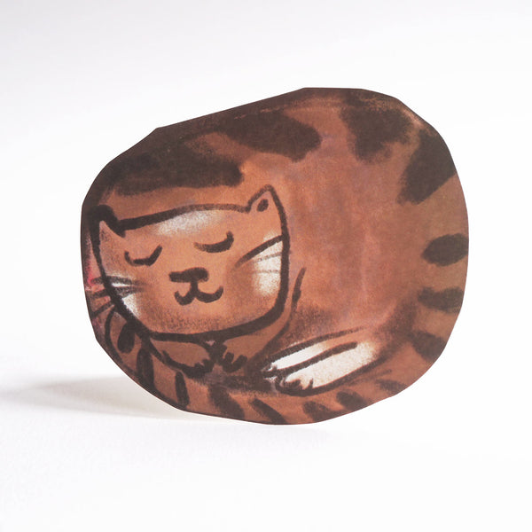 A die-cut greeting card featuring a hand-painted brown and black illustration of a sleeping cat, set against a plain white background.