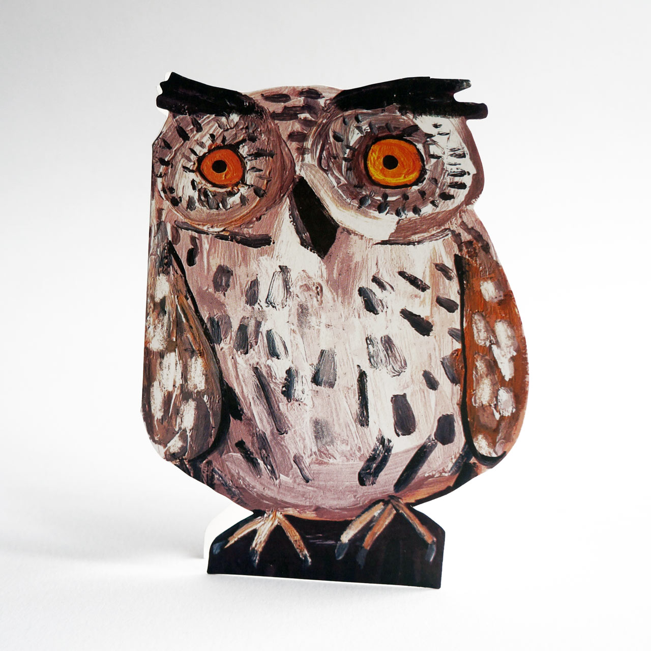 Die-cut card featuring a hand-painted Little Owl with large orange eyes, brown and white textured feathers, and black eyebrows and beak, standing on a black base against a light grey background.