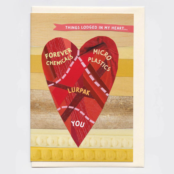 A greeting card featuring a large red heart made of layered materials with text labels including 'FOREVER CHEMICALS', 'MICRO PLASTICS', 'LURPAK', and 'YOU'. The top banner reads 'THINGS LODGED IN MY HEART.