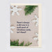 A Christmas greeting card with a beige background, featuring the text 'There's always a shit one in a multi-pack of Christmas cards, isn't there?' in dark navy lettering. The card is decorated with white paper snowflakes and green pine branches, shown with a cream envelope against a light gray background.