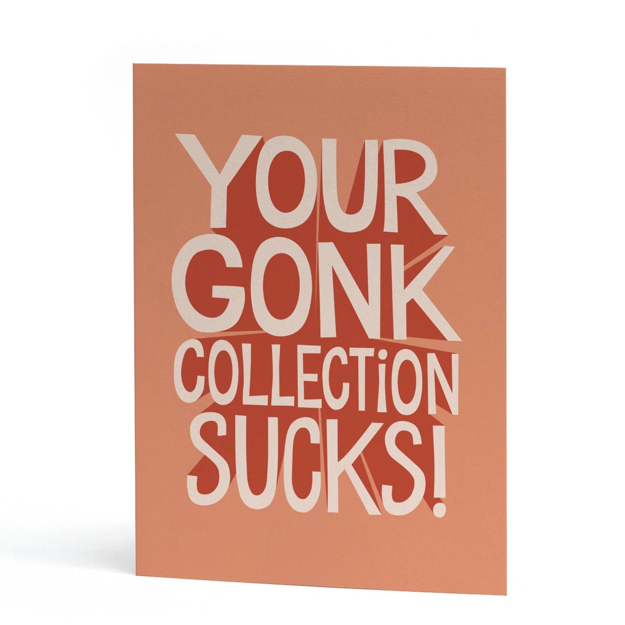 An A6 Christmas card with a terracotta orange background and bold white text reading 'YOUR GONK COLLECTION SUCKS!'.